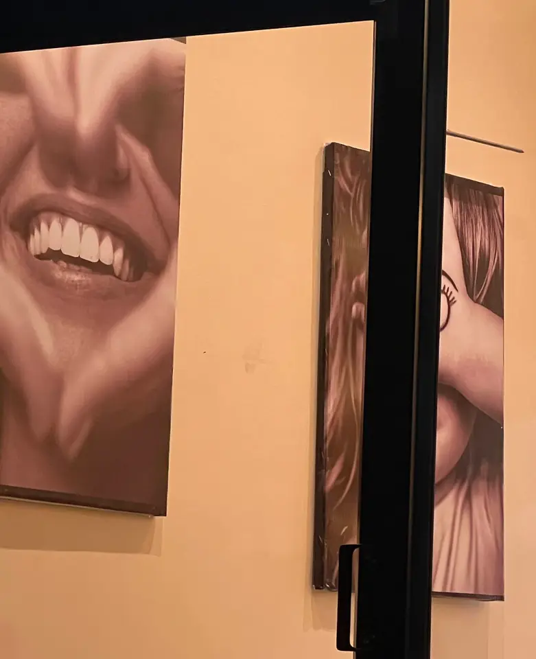 A gallery of framed black-and-white smile portraits at Smile Line Sodepur