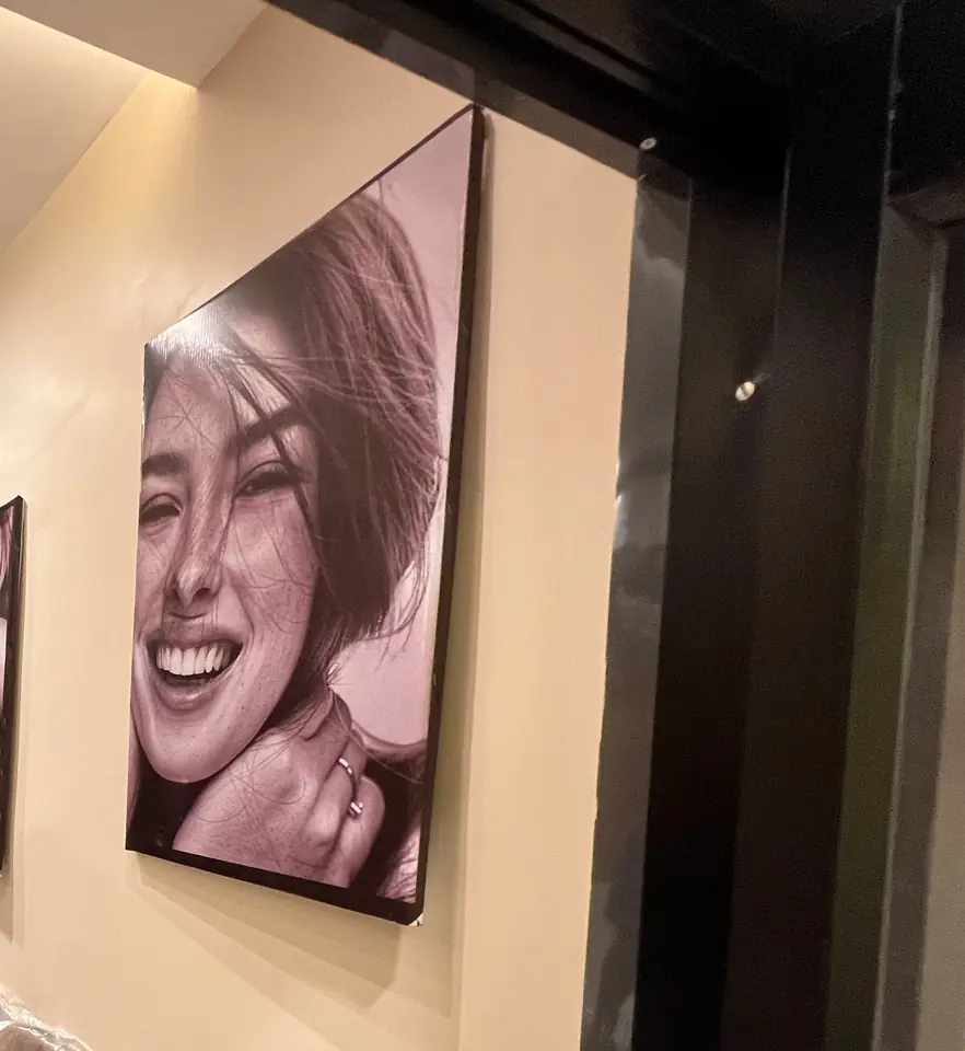 Black-and-white smile portraits arranged on the Smile Line reception wall